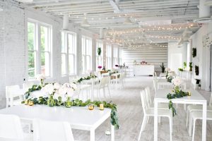 White tables and floral tablescapes at Flat 51