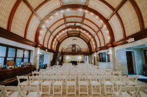 Inside of a wedding venue with chairs set up